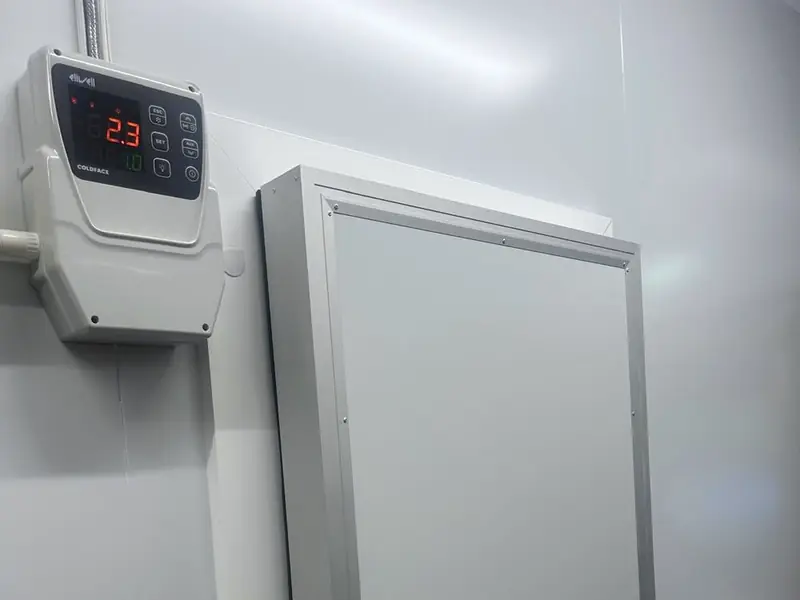 Cold room controller reading 2.3 degrees beside the insulated door