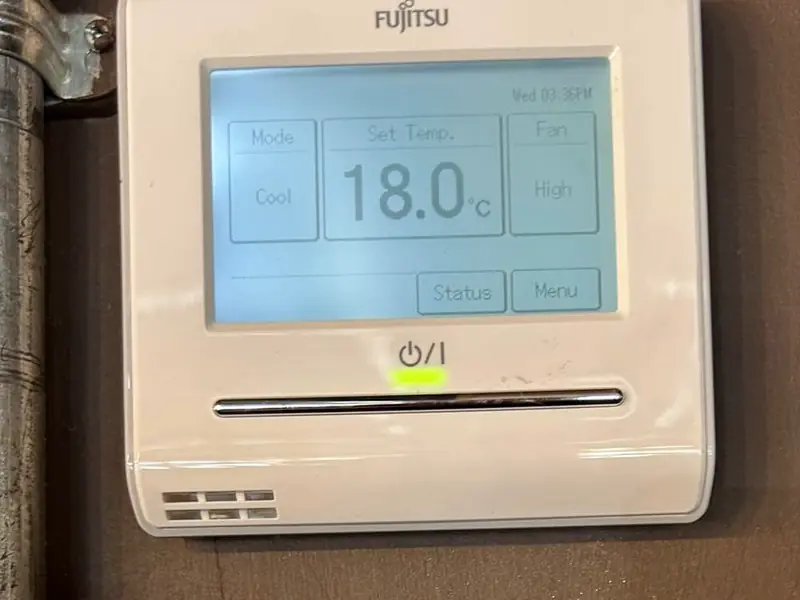 Wall controller showing cool mode set to 18 degrees